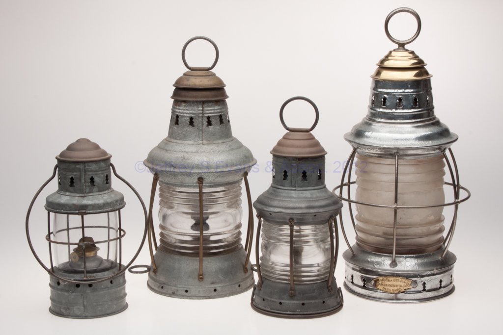 SHEET IRON WITH BRASS CAP MARINE LANTERNS, LOT OF : SHEET IRON WITH BRASS CAP MARINE LANTERNS, LOT OF FOUR, comprising a Topping Bros. example with colorless 360 degree unpatterned lens and bail handle; and three examples with ring handle, including a 