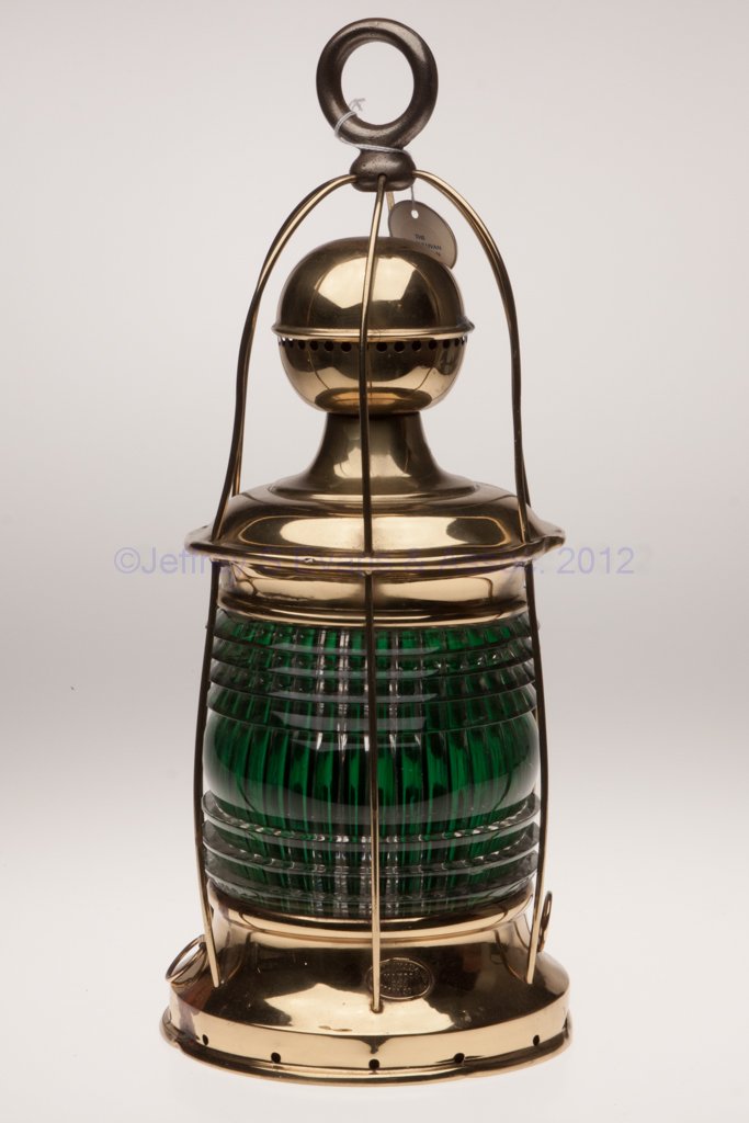S. M. AIKMAN & CO. BRASS SIGNAL MARINE LANTERN: S. M. AIKMAN & CO. BRASS SIGNAL MARINE LANTERN, polished, iron ring handle, base with maker's plate marked "S. M. AIKMAN & CO / 261 PEARL ST N.Y" and two tie-down rings, 360 degree A. Tufts fresnel le