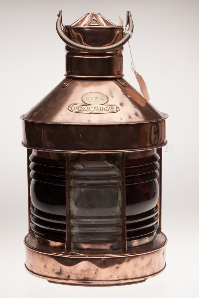 G. N. F. CO. BRASS AND COPPER TRAWLING MARINE LANT: G. N. F. CO. BRASS AND COPPER TRAWLING MARINE LANTERN, polished, bail handle, flat back with hinged door, hinged cap, brass maker's plate marked "G. N. F. CO" over "TRAWLING", three fresnel lenses in 