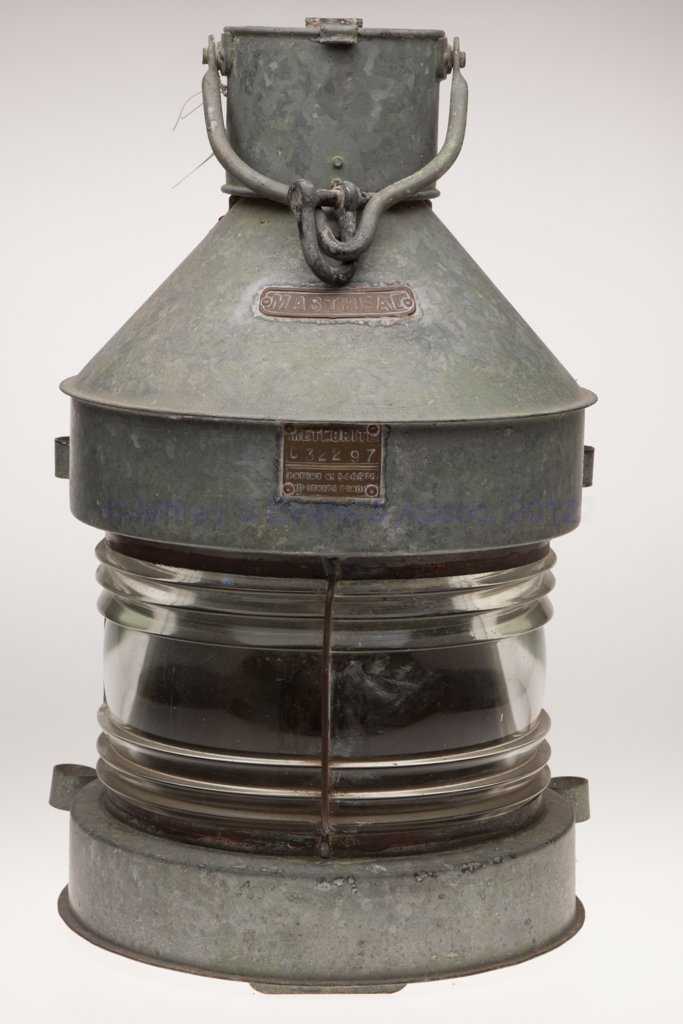 METEORITE GALVANIZED SHEET IRON MASTHEAD MARINE LA: METEORITE GALVANIZED SHEET IRON MASTHEAD MARINE LANTERN, bail handle and hinged cap, flat back with sliding door, top and bottom each with two mounting lugs, cover with a brass plate marked "MASTHEAD"