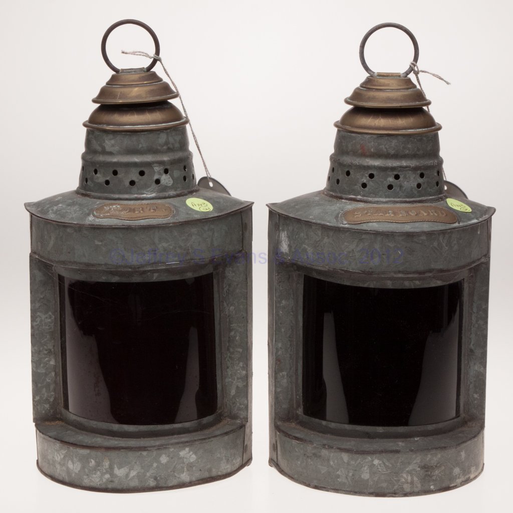 BRASS AND GALVANIZED SHEET IRON PORT AND STARBOARD: BRASS AND GALVANIZED SHEET IRON PORT AND STARBOARD MARINE LANTERNS, PAIR, triangular form with ring handle and mounting bracket, remaining side with a hinged door, one with a brass plate marked "PORT"