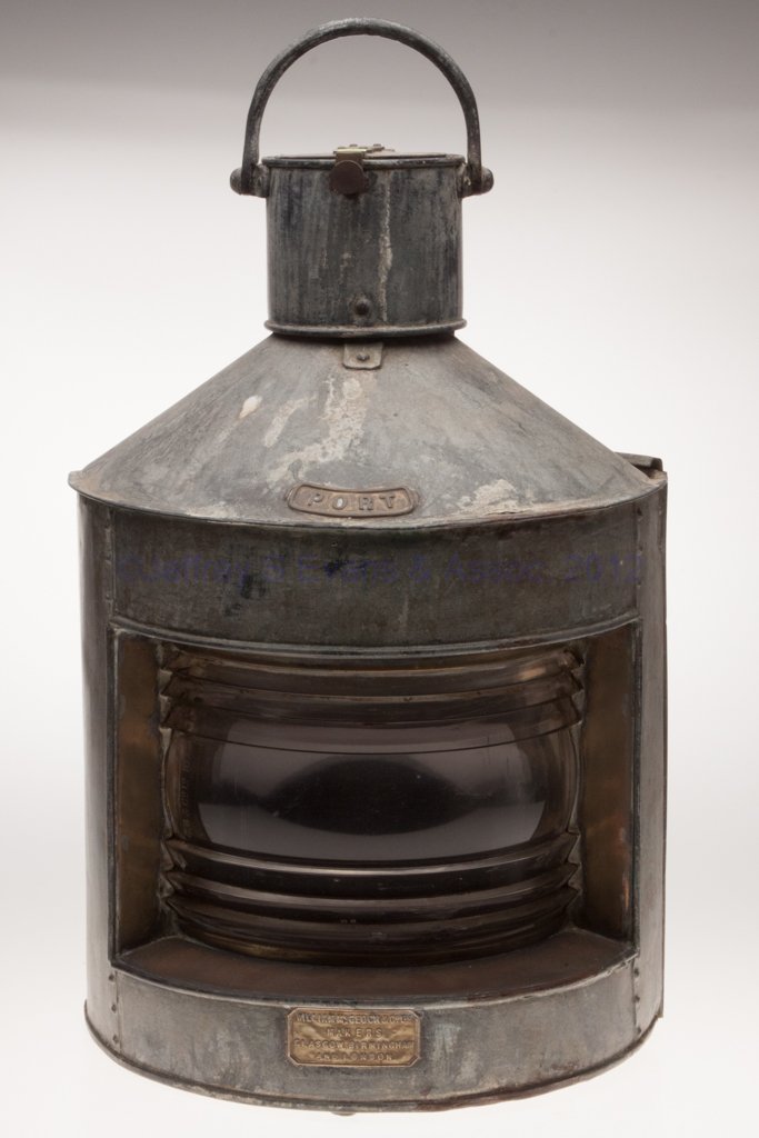 WILLIAM MCGEOCH & CO. LTD GALVANIZED SHEET IRON PO: WILLIAM MCGEOCH & CO. LTD GALVANIZED SHEET IRON PORT MARINE LANTERN, triangular form with bail handle, mounting bracket and sliding door, brass plate marked "PORT" and base with plate marked "WILLIAM 