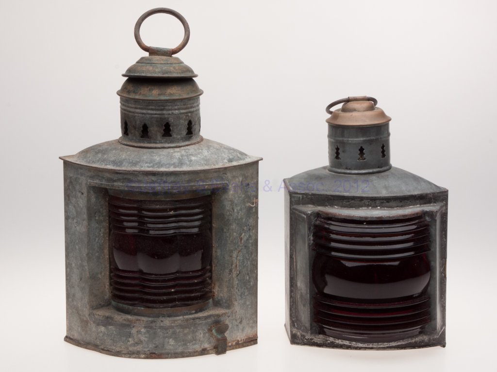 NEW YORK MANUFACTURER'S GALVANIZED SHEET IRON MARI: NEW YORK MANUFACTURER'S GALVANIZED SHEET IRON MARINE LANTERNS, LOT OF TWO, each with brass cap and ring handle, triangular form with mounting bracket and door, comprising a S. S. Thorp & Co., and a Na