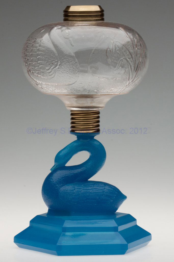 ATTERBURY SWAN STAND LAMP: ATTERBURY SWAN STAND LAMP, colorless embossed Swan font, starch blue alabaster hexagonal base, No. 2 Taplin-Brown collar, screw socket connector with patent information. Atterbury & Co. Fourth quarter