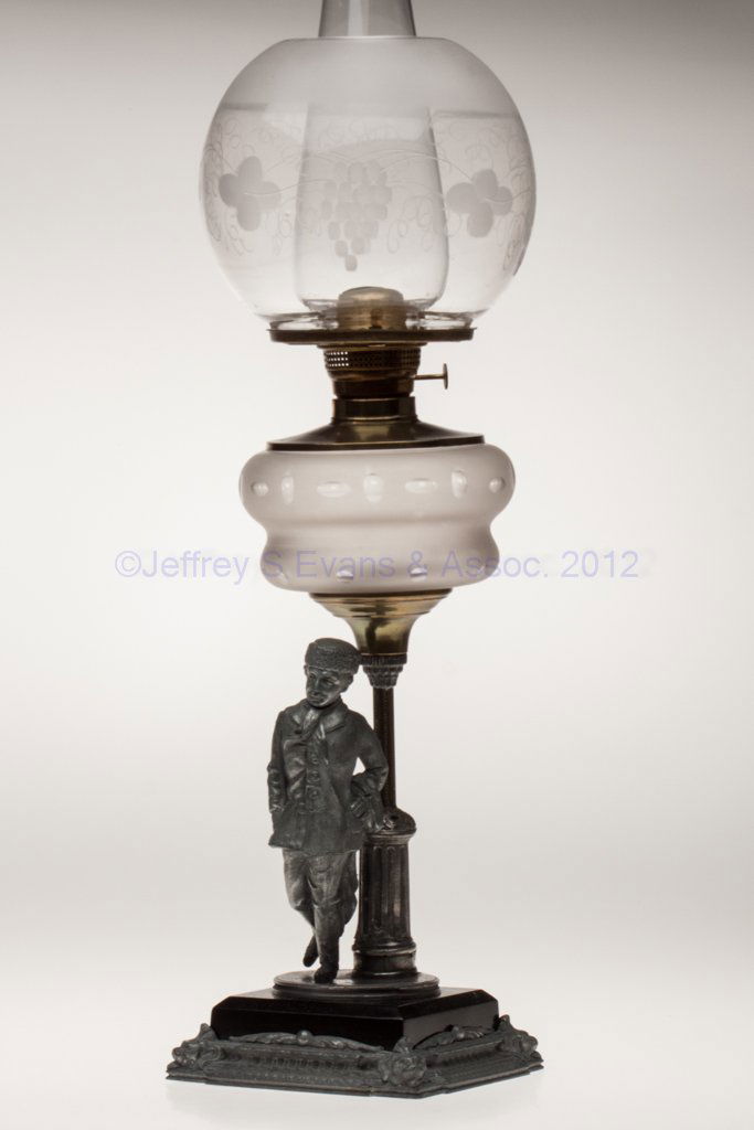 BRADLEY & HUBERT NO. 1305B FIGURAL STAND LAMP: BRADLEY & HUBERT NO. 1305B FIGURAL STAND LAMP, colorless font with frosted finish and with cut punty and oval pattern, stem depicting a man on ice skate's and holding a blanket, black metal step fitte