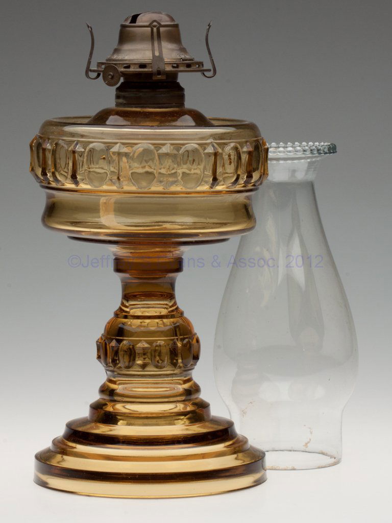 ANGELUS STAND LAMP: ANGELUS STAND LAMP, amber, No. 2 Taplin-Brown collar. Fitted with a period slip burner and chimney. Fourth quarter 19th century. 10 1/8" H to top of collar, 5 7/8" D base. Literature: Pattern as Kamm