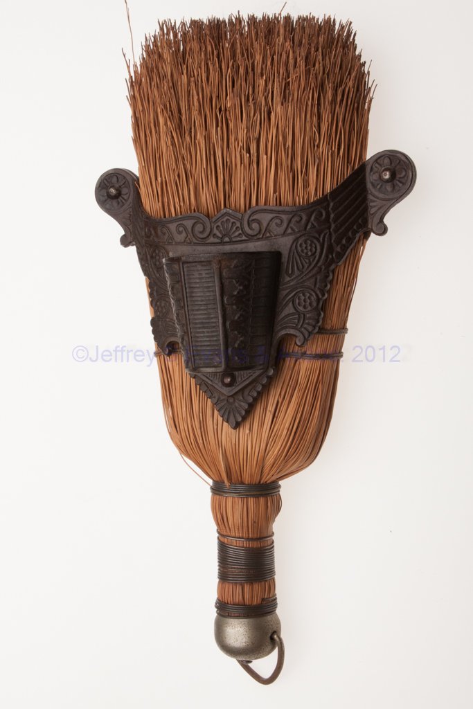 CAST IRON WALL-MOUNT MATCH HOLDER: CAST IRON WALL-MOUNT MATCH HOLDER, bowed front with opening and a single open compartment with central striking plate. Late 19th/early 20th century. 4 3/4" HOA, 5 3/8" W. Provenance: From the collecti