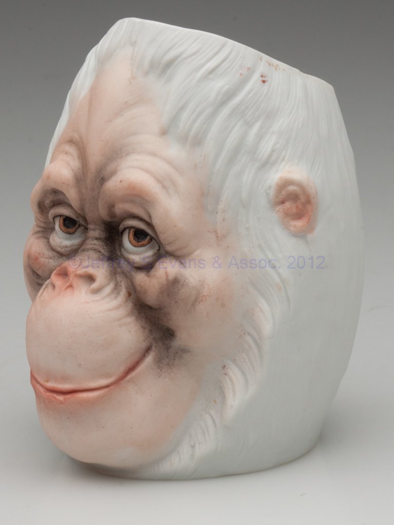 BISQUE FIGURAL MONKEY FAIRY / NURSERY LIGHT: BISQUE FIGURAL MONKEY FAIRY / NURSERY LIGHT, bust with solid molded eyes, marked "Ceschutzt" on reverse above base. Germany. Fourth quarter 19th century. 4" H. Provenance: From the collection of the l