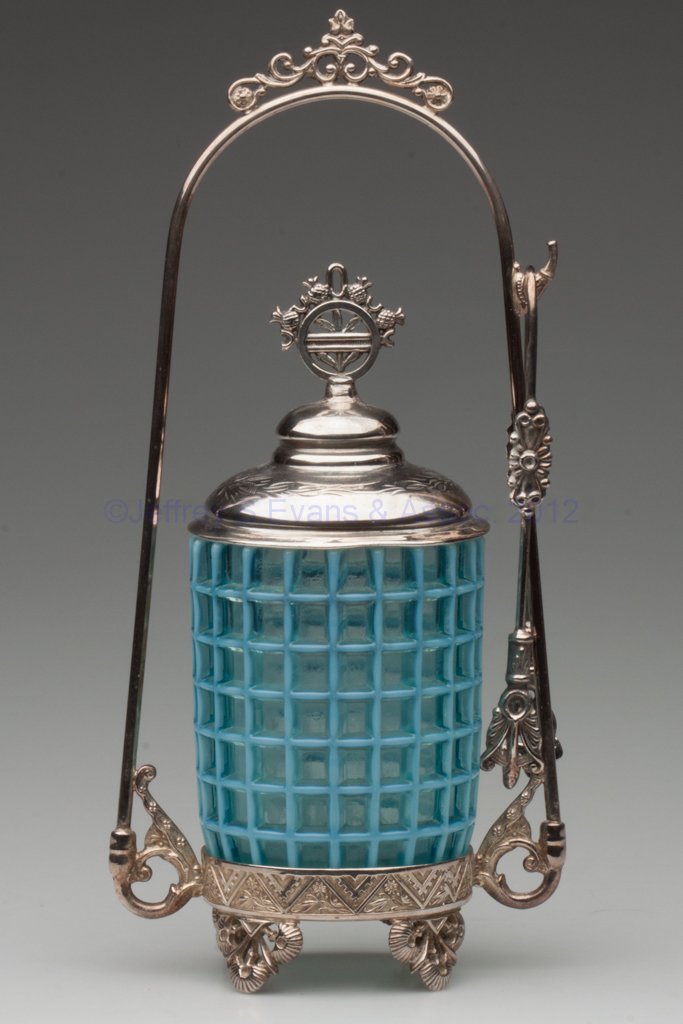 BEATTY HONEYCOMB PICKLE CASTER: BEATTY HONEYCOMB PICKLE CASTER, blue opalescent, Barbour Bros. #107 quadruple-plate stand with tongs. Beatty & Sons, Tiffin, OH. Fourth quarter 19th century. 11 1/4" HOA, 4 1/4" H jar. Provenance: Fro