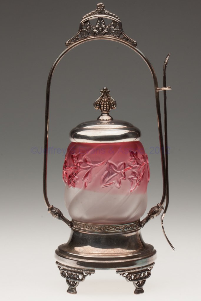 ROYAL IVY PICKLE CASTER: ROYAL IVY PICKLE CASTER, frosted rubina, Anchor Silver Plate Co. quadruple-plate stand with fork. Northwood Glass Co. Fourth quarter 19th century. 11 1/2" HOA, 3 1/2" H jar. Provenance: From the colle