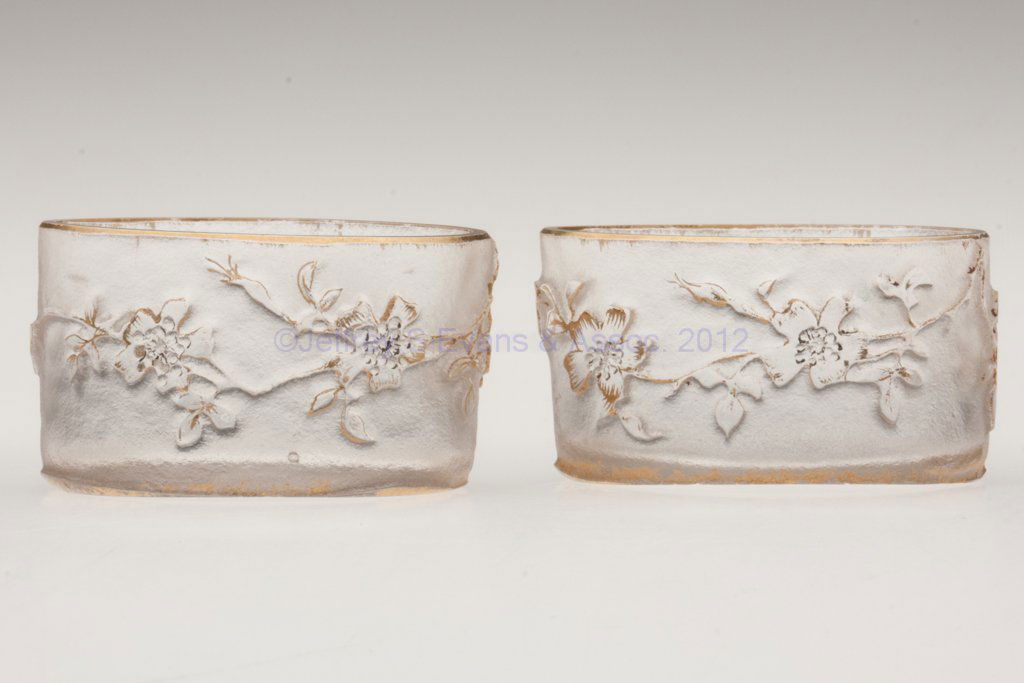 DAUM NANCY FRENCH CAMEO PAIR OF OPEN SALTS: DAUM NANCY FRENCH CAMEO PAIR OF OPEN SALTS, colorless with gilt highlights, oval form with acid-etched apple blossoms, faint gilt signatures under bases. France. Late 19th/early 20th century. 1" H, 1