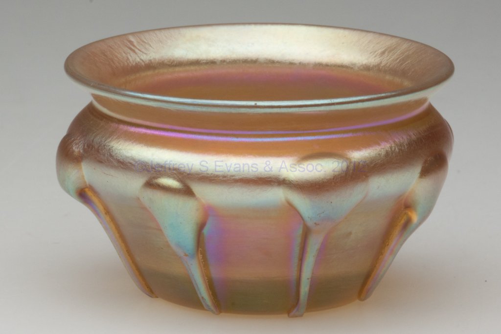 TIFFANY FAVRILE OPEN SALT: TIFFANY FAVRILE OPEN SALT, gold iridescent, decorated with eight applied lily pads or controlled drips, signed "L.C.T." outside the polished pontil mark. Louis Comfort Tiffany & Co. First quarter 20th