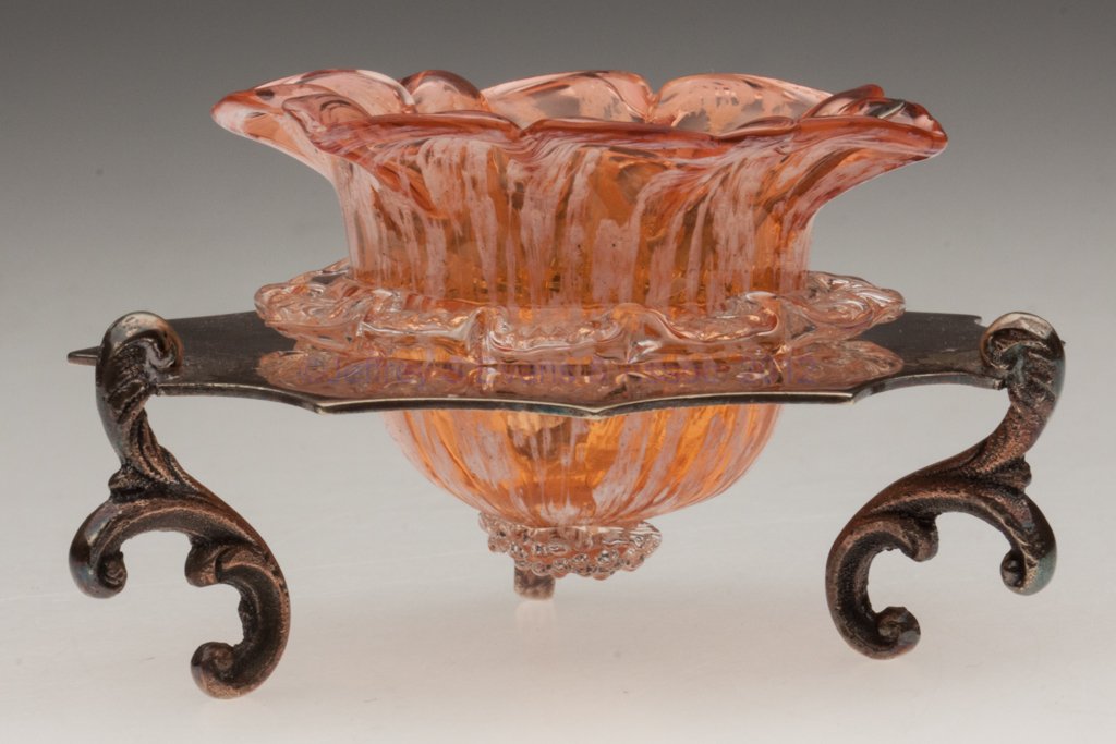 PELOTON SPATTER DECORATED OPEN SALT: PELOTON SPATTER DECORATED OPEN SALT, apricot and opal with applied colorless rigaree and berry prunt, six-petal flower form, fitted in a "H C & Co. / EPNS" stand with three scroll feet, Birmingham sil