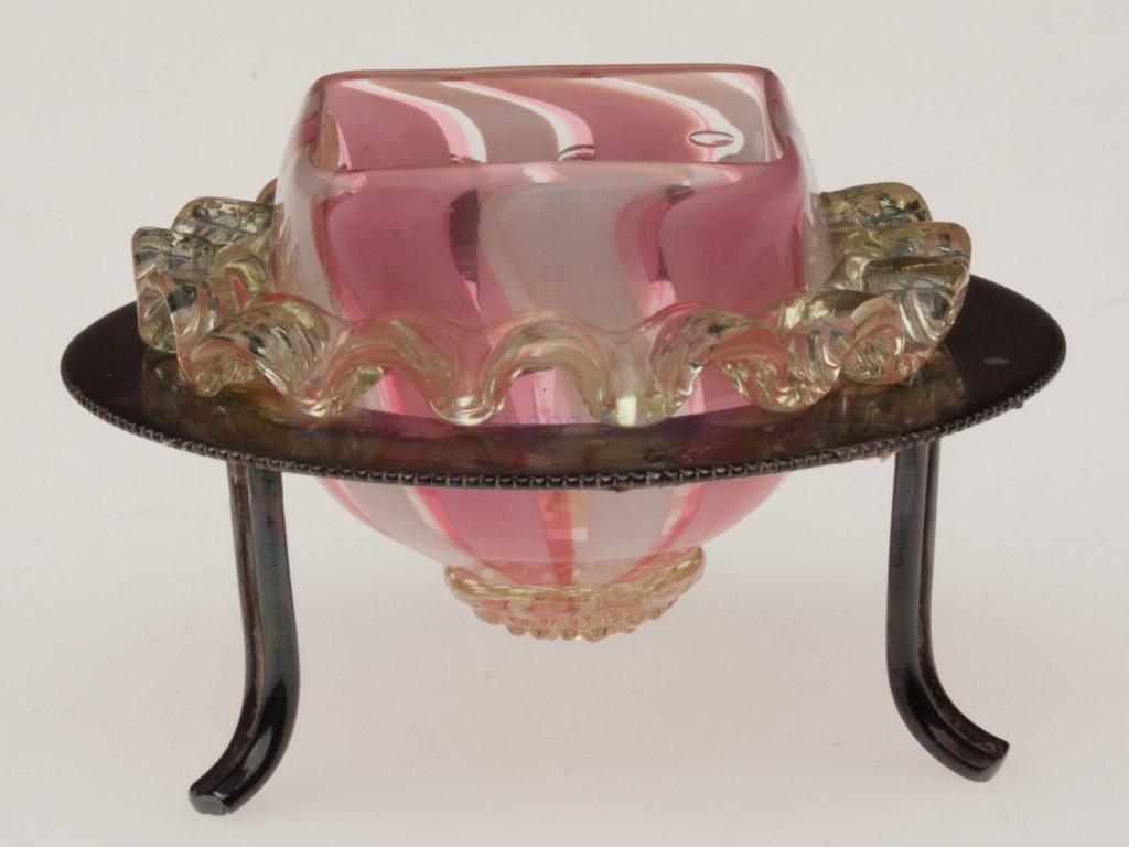 RIBBON STRIPED OPEN SALT: RIBBON STRIPED OPEN SALT, opal and rose with applied vaseline (uranium) rigaree and berry prunt, square rim, fitted in an unmarked silver-plated stand with three feet. Late 19th/early 20th century. 1 