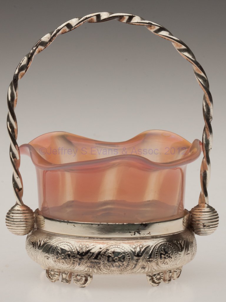 MONOT-STUMPF, PANTIN, RIB-OPTIC OPEN SALT: MONOT-STUMPF, PANTIN, RIB-OPTIC OPEN SALT, light and dark apricot striped opalescent, polished pontil mark, fitted in an Acme Silver Co., Toronto silver-plate stand with handle. Fourth quarter 19th ce