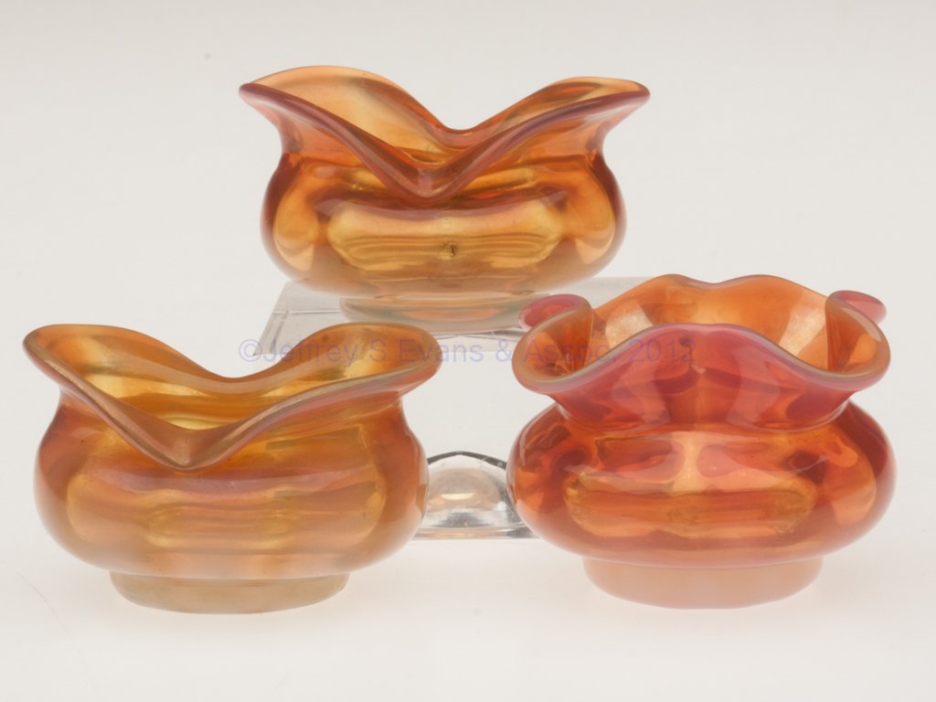 MONOT-STUMPF, PANTIN, RIB-OPTIC OPEN SALTS, LOT O: MONOT-STUMPF, PANTIN, RIB-OPTIC OPEN SALTS, LOT OF THREE, light and dark apricot striped opalescent, comprising two boat form and one quatrefoil form, each with polished pontil mark. Fourth quarter 19