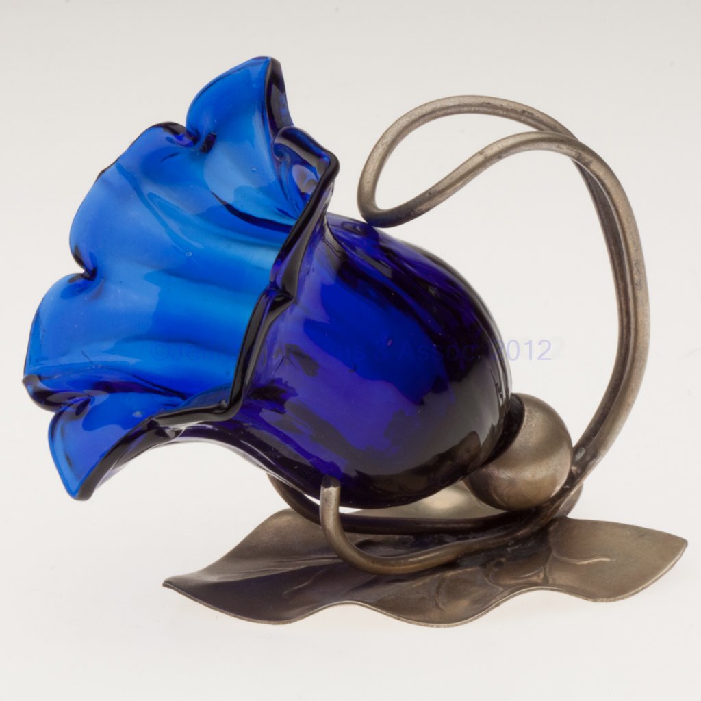 RIB-OPTIC OPEN SALT / TOOTHPICK HOLDER: RIB-OPTIC OPEN SALT / TOOTHPICK HOLDER, cobalt blue, flower form fitted in a leaf-form "EPNS" stand. Late 19th/early 20th century. 2 3/4" H, 2 1/2" D rim. Literature: Parallels Jzyk/Robertson - Open S