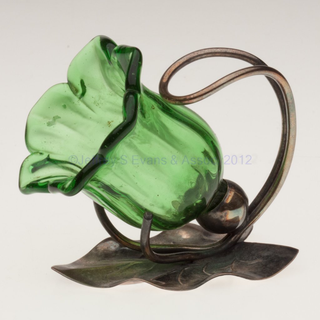 RIB-OPTIC OPEN SALT / TOOTHPICK HOLDER: RIB-OPTIC OPEN SALT / TOOTHPICK HOLDER, green, flower form fitted in a leaf-form "EP" stand. Late 19th/early 20th century. 2 3/4" HOA, 2" rim. Literature: Jzyk/Robertson - Open Salt Compendium, p. 48,