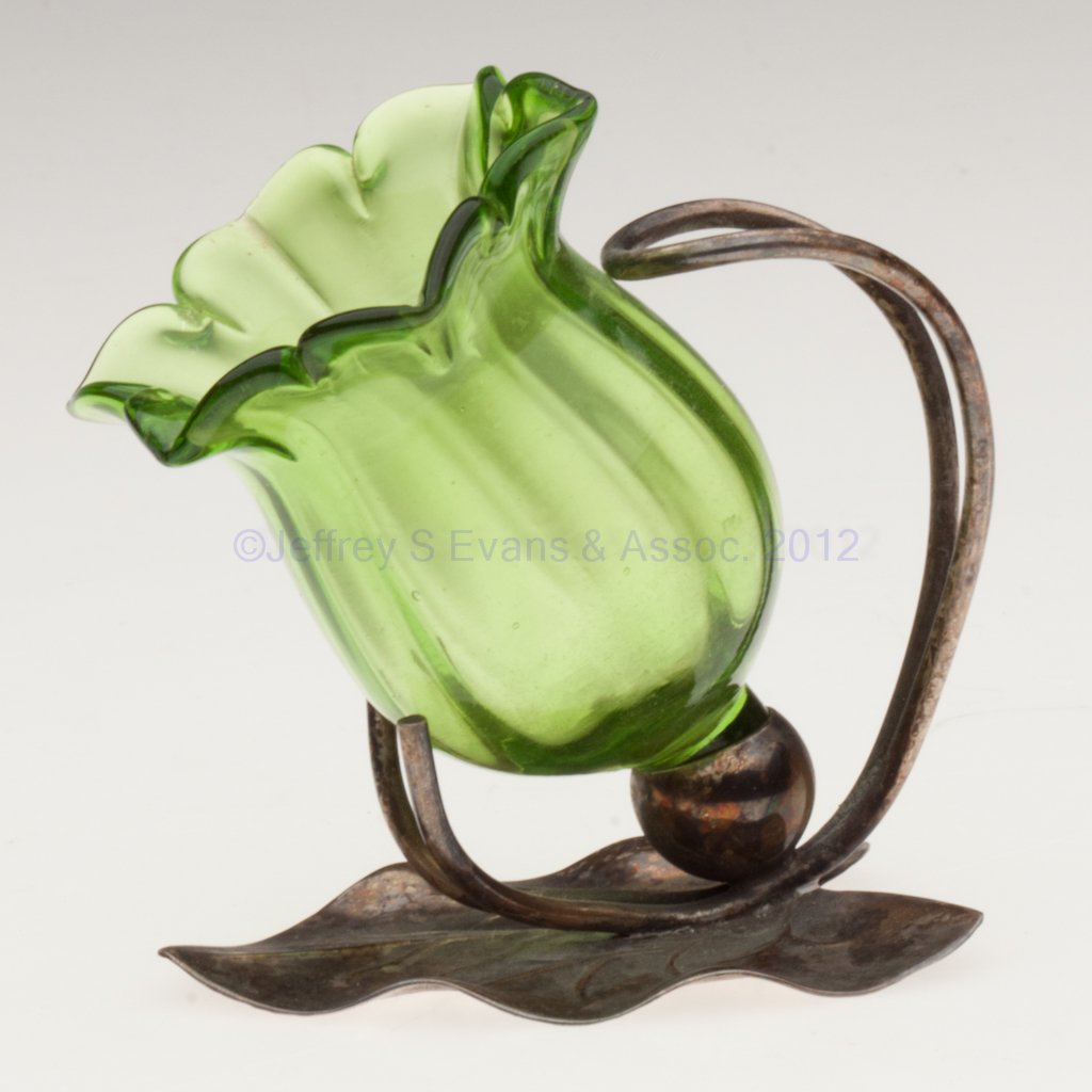 RIB-OPTIC OPEN SALT / TOOTHPICK HOLDER: RIB-OPTIC OPEN SALT / TOOTHPICK HOLDER, green, flower form fitted in a leaf-form "EPNS" stand. Late 19th/early 20th century. 3" H, 2 1/8" D rim. Literature: Jzyk/Robertson - Open Salt Compendium, p. 4