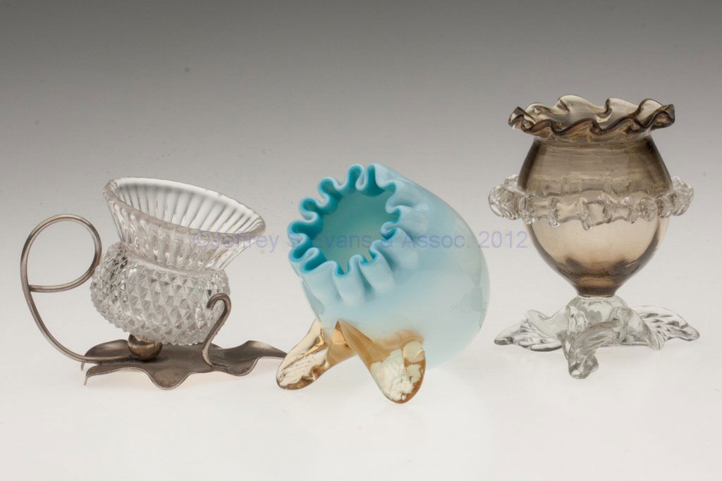 ASSORTED OPEN SALTS / TOOTHPICK HOLDERS, LOT OF T: ASSORTED OPEN SALTS / TOOTHPICK HOLDERS, LOT OF THREE, comprising a cased pale blue tilted egg-form with two feet, a brown upright egg-form with colorless rigaree and base, and a colorless pressed thi