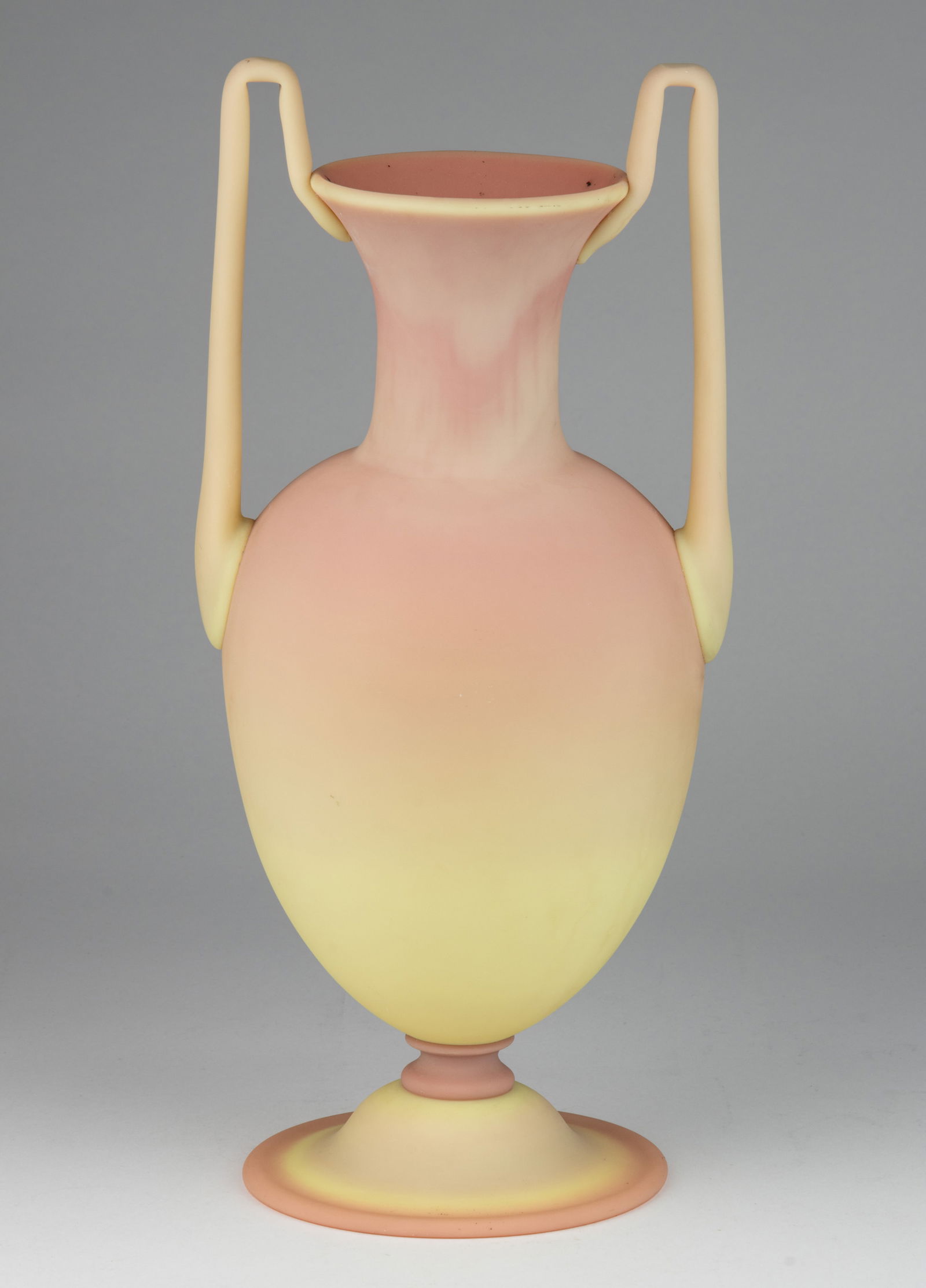 MT. WASHINGTON BURMESE EGYPTIAN-FORM ART GLASS VASE: MT. WASHINGTON BURMESE EGYPTIAN-FORM ART GLASS VASE, plush finish, bulbous amphora or vasiform body with moderately sized neck and flaring rim, angular arching applied handles, underside wit