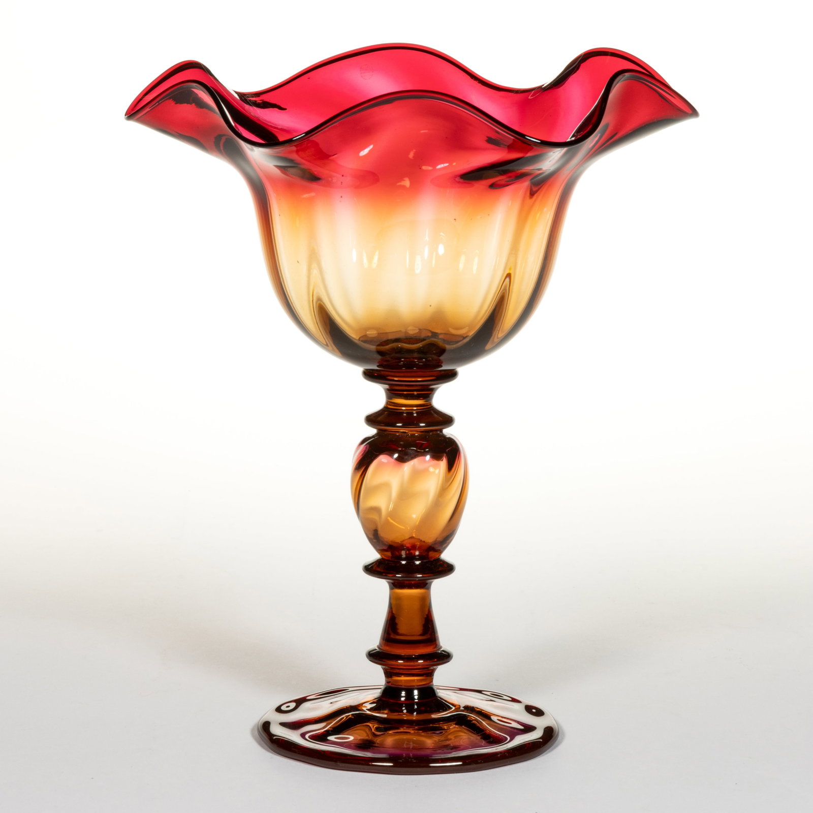SIGNED LIBBEY NO. 3017 AMBERINA PANEL-OPTIC COMPOTE: SIGNED LIBBEY NO. 3017 AMBERINA PANEL-OPTIC COMPOTE, deep bowl with a gauffered rim, raised on a central hollow swirled standard with a short and tall spool connector above and below, applied cir