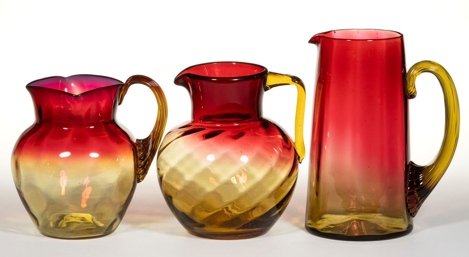 VICTORIAN AMBERINA OPTIC GLASS PITCHERS, LOT OF THREE (1 of 1)