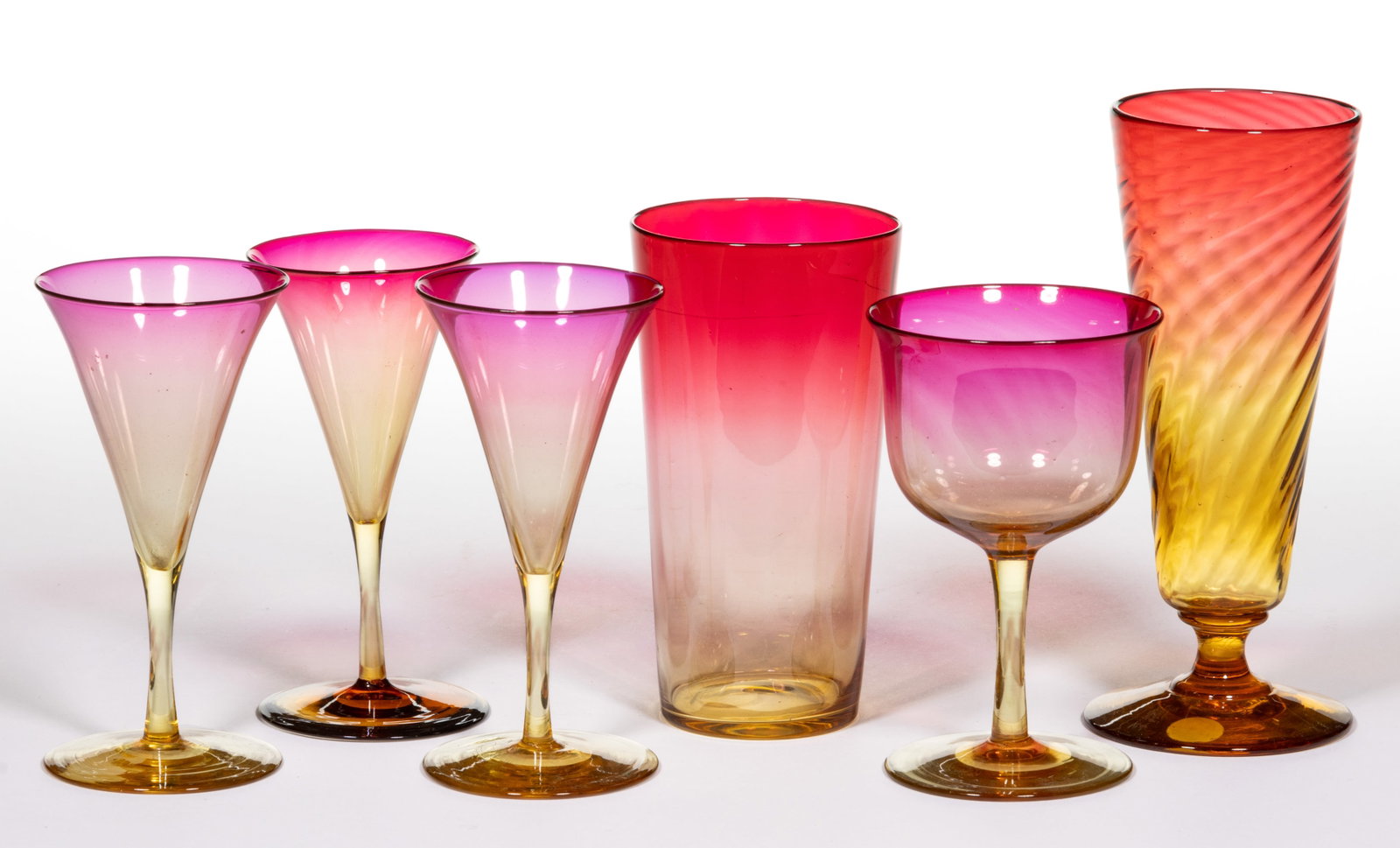 AMBERINA GLASS DRINKING ARTICLES, LOT OF SIX: AMBERINA GLASS DRINKING ARTICLES, LOT OF SIX, comprising three conical wines, a wine with a deep bowl, a juice tumbler, and an ale. Various makers. Fourth quarter 19th/early 20th century. 4 1/4" 