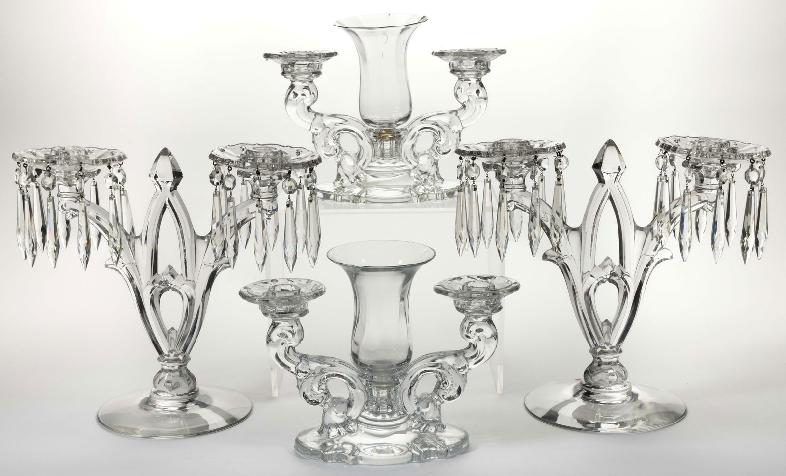 ASSORTED HEISEY PRESSED GLASS CANDLESTICKS, LOT OF FOUR: ASSORTED HEISEY PRESSED GLASS CANDLESTICKS, LOT OF FOUR, comprising two pairs of two-light candlesticks in No. 1513 Baroque with epergnes and No. 402 Gothic. Gothic pair retaining prisms, Baroque lack