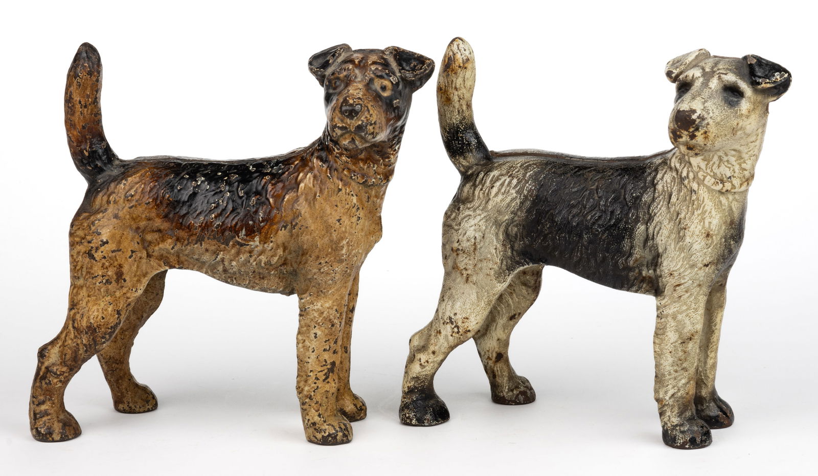 ASSORTED CAST-IRON FIGURAL FOX TERRIER DOG - FACING RIGHT DOORSTOPS, LOT OF TWO: ASSORTED CAST-IRON FIGURAL FOX TERRIER DOG - FACING RIGHT DOORSTOPS, LOT OF TWO, each of full-figured form in standing position, original paint including a black/brown example and a black an