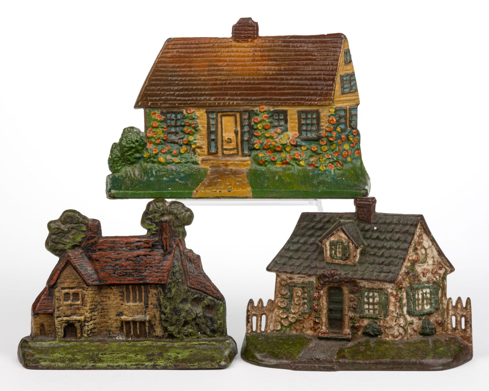 ASSORTED CAST-IRON FIGURAL COTTAGE DOORSTOPS, LOT OF THREE: ASSORTED CAST-IRON FIGURAL COTTAGE DOORSTOPS, LOT OF THREE, each with original polychrome paint, comprising two of solid half-back form, including a cottage depicting Washington's House "Sulg