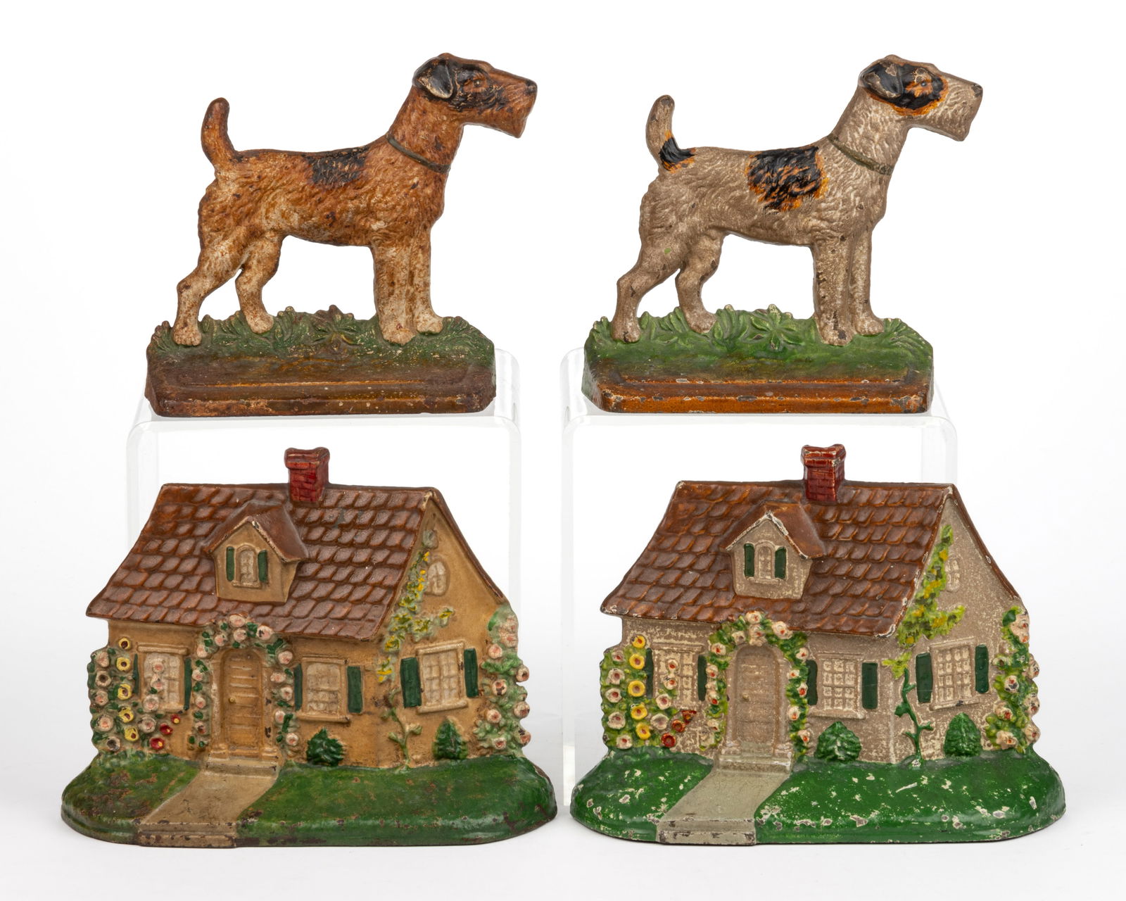 HUBLEY CAST-IRON FIGURAL BOOKENDS AND DOORSTOPS, LOT OF FOUR: HUBLEY CAST-IRON FIGURAL BOOKENDS AND DOORSTOPS, LOT OF FOUR, each with original paint, comprising two half-back form No. 211 cottages, each reverse impressed "211"; and a pair of Airedale/F
