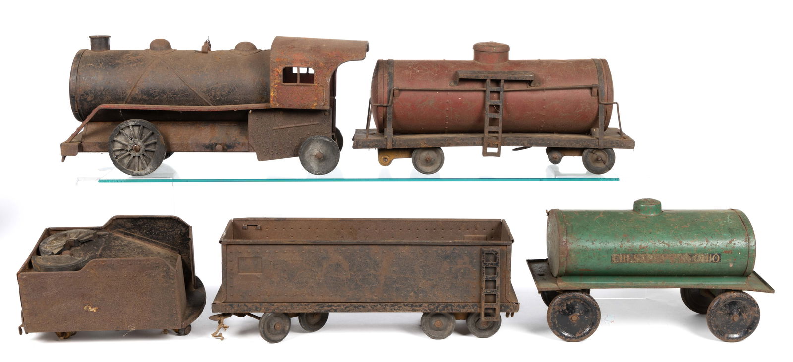 COR-COR TOYS PRESSED STEEL TRAIN SET, LOT OF FIVE CARS: COR-COR TOYS PRESSED STEEL TRAIN SET, LOT OF FIVE CARS, of large-scale, including an engine, a coal car, two tanker cars, and a freight car; the engine with rubber wheels which read "COR-COR