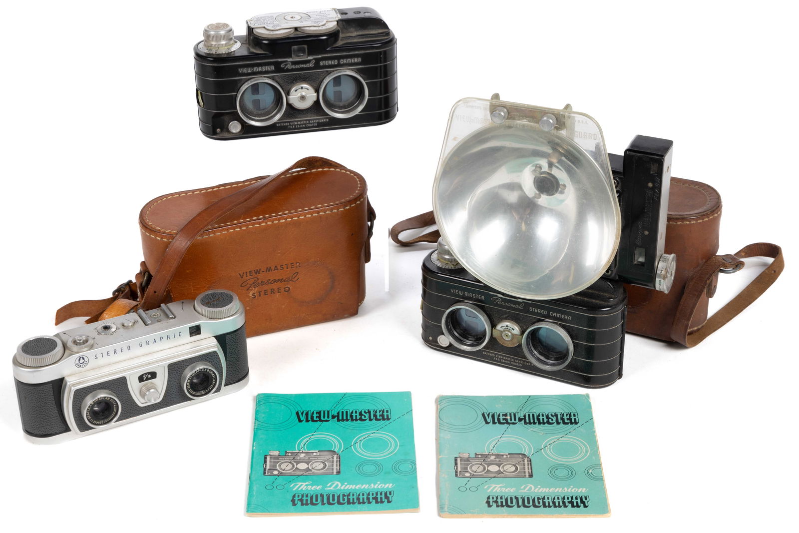 ASSORTED VINTAGE STEREO CAMERAS AND ACCESSORIES, LOT OF THREE: ASSORTED VINTAGE STEREO CAMERAS AND ACCESSORIES, LOT OF THREE, comprising a Graflex Stereo Graphic with twin f:4 35mm Graflar lenses, and two View-Master Personal Stereo Cameras made by Stereocraft En