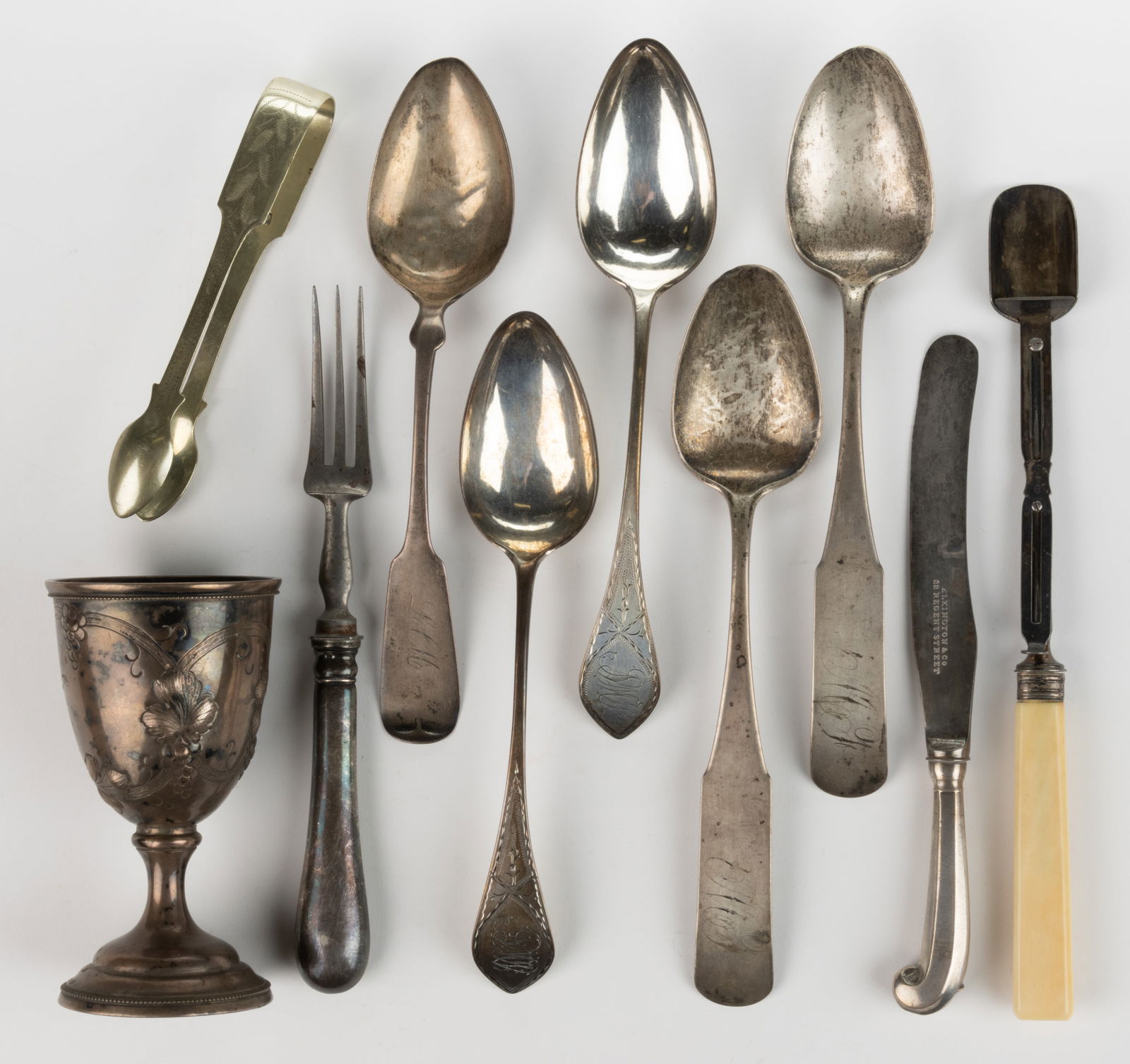 ASSORTED COIN SILVER AND OTHER UTENSILS AND GOBLET, LOT OF TEN: ASSORTED COIN SILVER AND OTHER UTENSILS AND GOBLET, LOT OF TEN, comprising an unmarked small goblet being silver-plated or possibly coin silver having repousse, chased, and engraved grapevine decorati