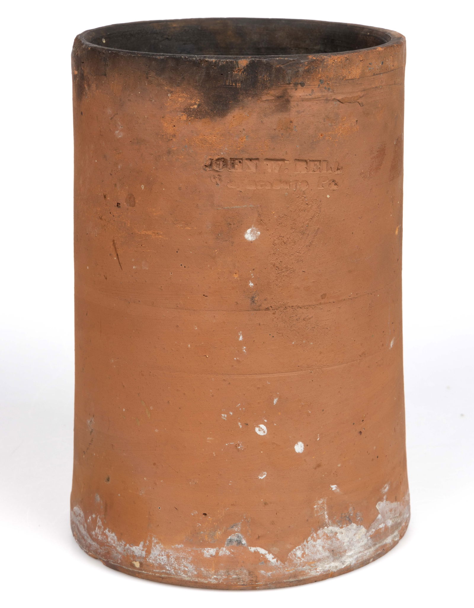 STAMPED "JOHN W. BELL / WAYNESBORO, PA" PENNSYLVANIA EARTHENWARE / REDWARE CHIMNEY FLUE LINER: STAMPED "JOHN W. BELL / WAYNESBORO, PA" PENNSYLVANIA EARTHENWARE / REDWARE CHIMNEY FLUE LINER, unglazed, of slightly-tapered cylindrical form with an open top and open base. An inscription r