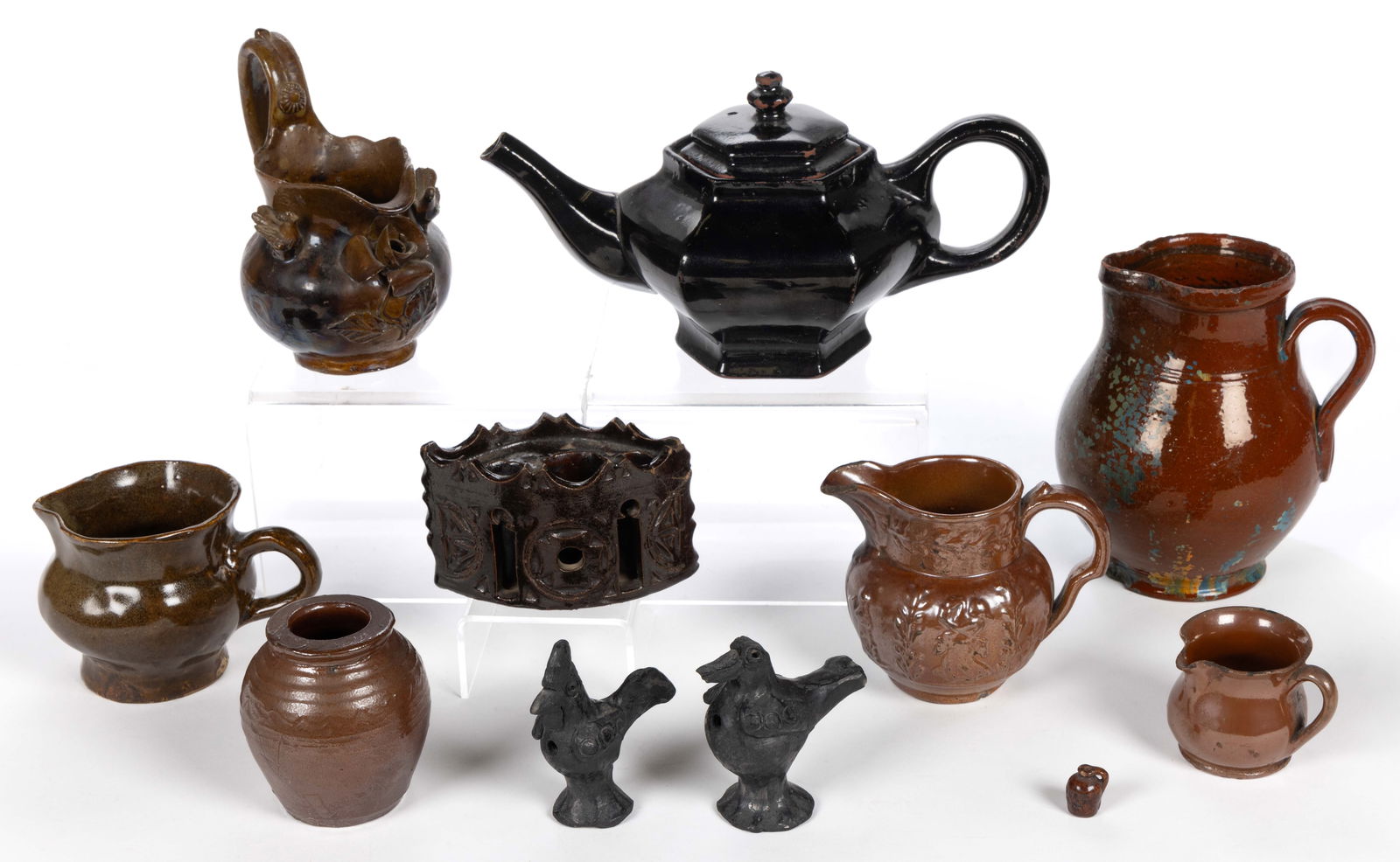 ASSORTED POTTERY ARTICLES, LOT OF 11: ASSORTED POTTERY ARTICLES, LOT OF 11, including a miniature jug stamped "GETTYSBURG / JULY, 1, 2, 3, 62.", a hexagonal redware teapot with dark brown/black glaze, dark a vesica piscis-f