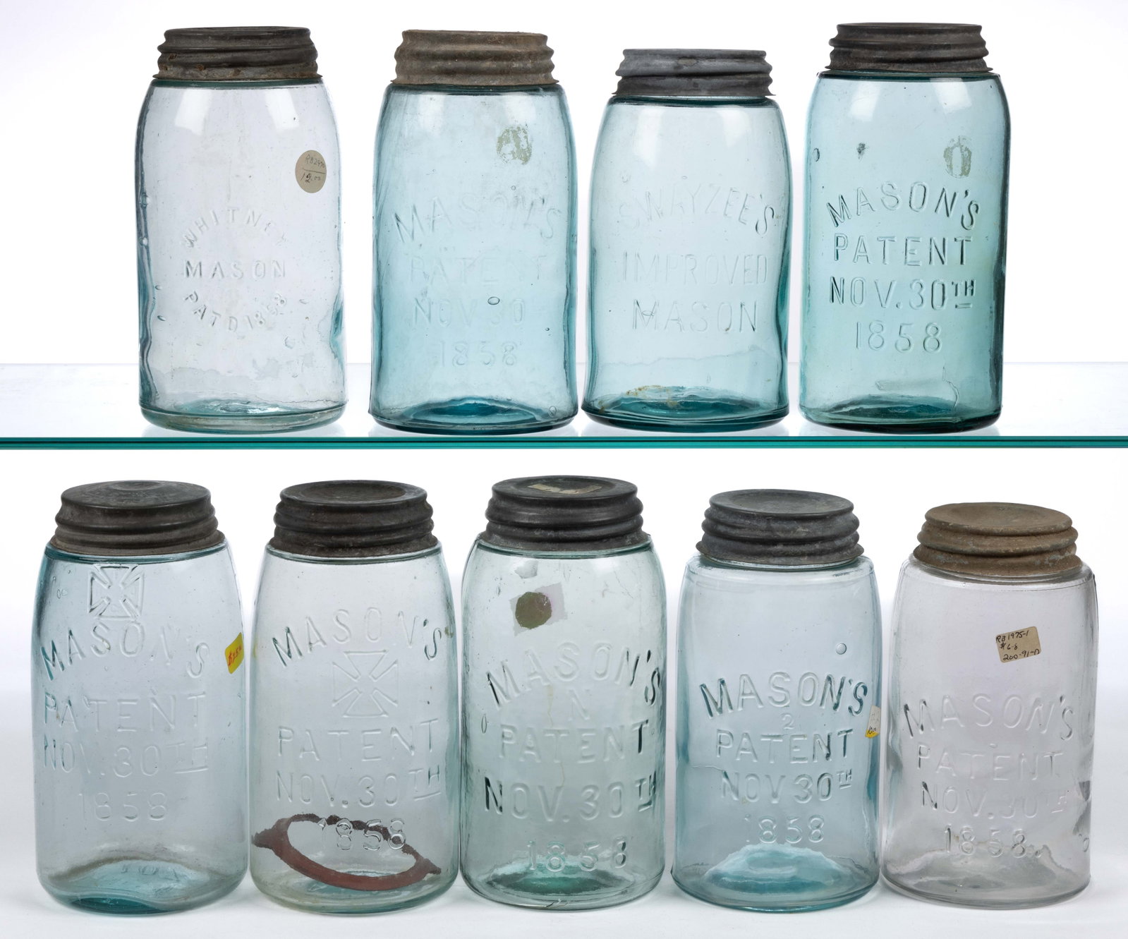 ASSORTED MASON'S PATENT FRUIT JARS, LOT OF NINE: ASSORTED MASON'S PATENT FRUIT JARS, LOT OF NINE, aqua and colorless quarts, including two having a Hero Cross to fronts with HFJCo embossed inside, a Swayzee's Improved, a Whitney Mason, 