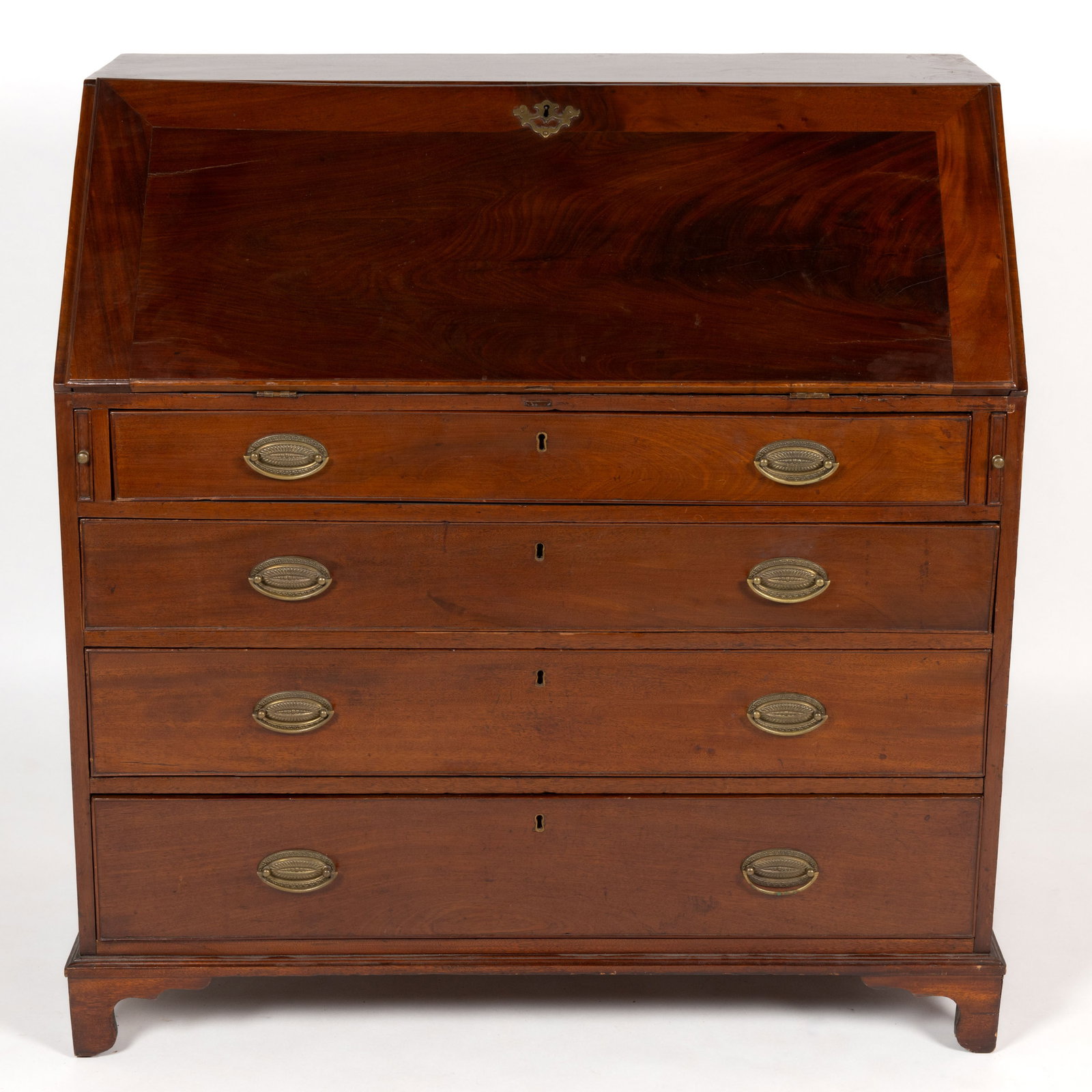 AMERICAN OR ENGLISH MAHOGANY SLANT FRONT DESK: AMERICAN OR ENGLISH MAHOGANY SLANT FRONT DESK, dovetailed case, full dust boards, the hinged slant lid concealing a fitted interior featuring central divided section flanked by two sets of four s