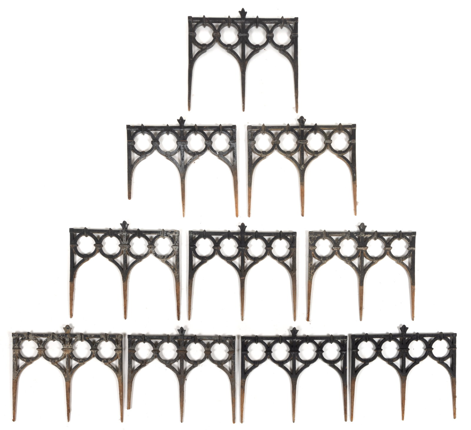 VICTORIAN CAST-IRON GARDEN EDGING / FENCING: VICTORIAN CAST-IRON GARDEN EDGING / FENCING, comprising ten sections each with a central fleur-de-lis over four circular designs which terminate in a gothic arch. Each is secured into the ground with 