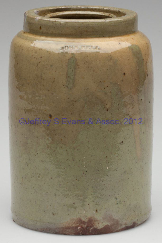 STAMPED "JOHN BELL", WAYNESBORO, PENNSYLVANIA STONE: STAMPED "JOHN BELL", WAYNESBORO, PENNSYLVANIA STONEWARE CANNING JAR, thick celadon-like glaze, quart capacity, cylindrical form with rounded shoulder and grooved, wax-seal rim. 1850-1880. 7" H, 3 3/4"