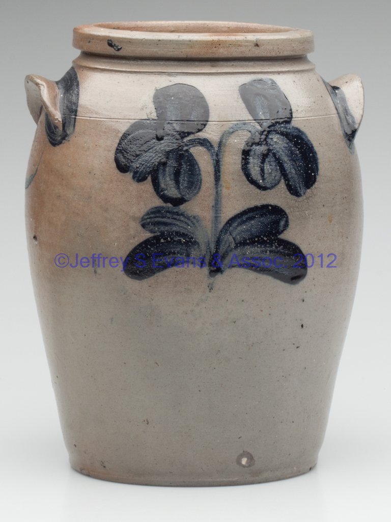BALTIMORE, MARYLAND DECORATED STONEWARE JAR: BALTIMORE, MARYLAND DECORATED STONEWARE JAR, salt glazed, "1 1/2" gallon capacity, ovoid body with pulled arched handles, incised shoulder ring, and collared square rim. Brushed cobalt double-bloom fl