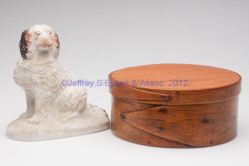 COUNTRY ACCESSORIES, LOT OF TWO: COUNTRY ACCESSORIES, LOT OF TWO, comprising a hollow chalkware seated spaniel, and a bentwood pantry box. 19th century. 6 1/2" H, 7 3/4" D. Provenance: Property of a Virginia collector.