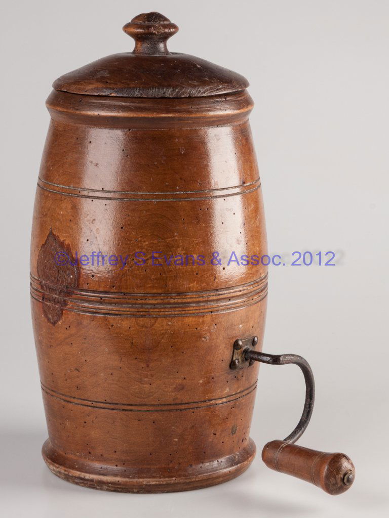 TURNED TREEN TABLE-TOP CHURN: TURNED TREEN TABLE-TOP CHURN, tall barrel form with side crank, dasher and cover. Mid 19th century. 13 1/2" HOA, 6" D rim. Provenance: The collection of Sally and the late Stanley Greenbaum, Williamsb