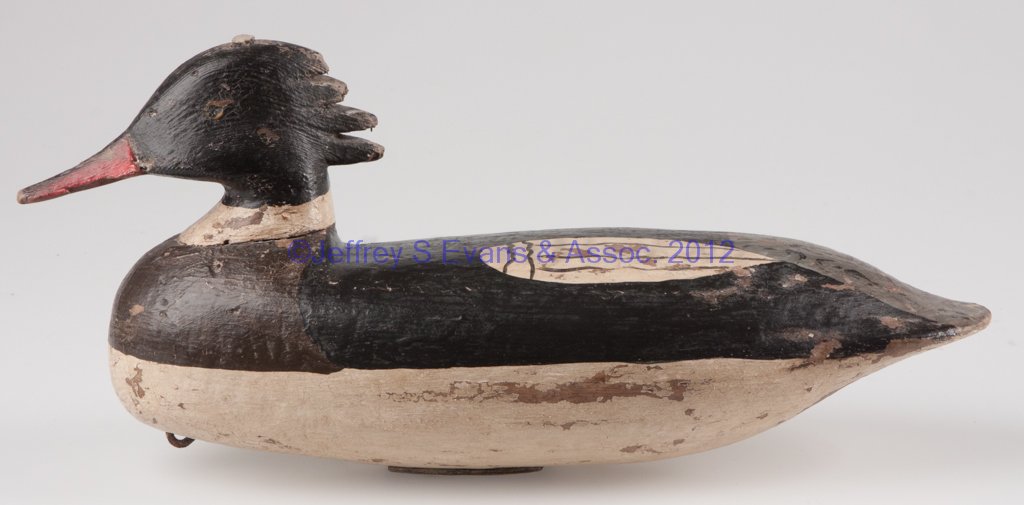 HOODED MERGANSER DRAKE DECOY: HOODED MERGANSER DRAKE DECOY, carved and painted wood, doweled head, old paint, square weight under base. 20th century. 7" H, 14 1/4" L. Provenance: The collection of Sally and the late Stanley Greenb