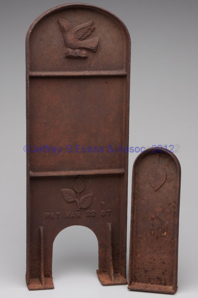 PATENTED CAST-IRON GRAVE-MARKER FRAMES, SET OF TWO: PATENTED CAST-IRON GRAVE-MARKER FRAMES, SET OF TWO, each of narrow arch-top form, head marker with a molded dove above the blank center panel for mounting name and dates, with a molded three-leaf spra