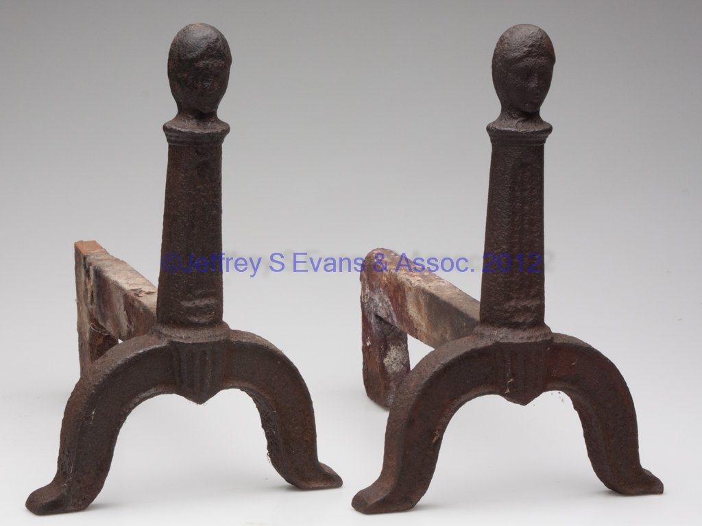 SHENANDOAH VALLEY OF VIRGINIA CAST-IRON PAIR OF FI: SHENANDOAH VALLEY OF VIRGINIA CAST-IRON PAIR OF FIREDOGS, each columnar shaft surmounted with a woman's head, raised on arched legs and flared feet, integral log supports. Probably Redwell Furnace, Pa