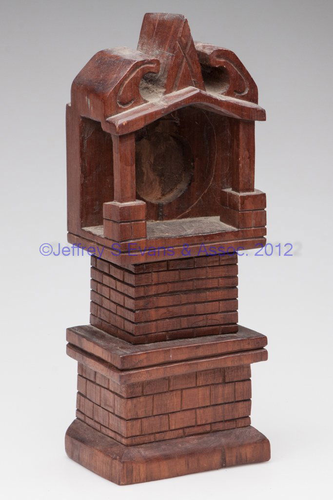 VALLEY OF VIRGINIA CARVED WALNUT WATCH HUTCH: VALLEY OF VIRGINIA CARVED WALNUT WATCH HUTCH, tall-case clock form carved from a single block, cut out for pocket watch. Original varnished surface, First half 20th century. 12 1/2" H, 4 5/8" x 3 1/4"