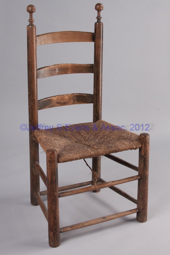 VIRGINIA OR NORTH CAROLINA LADDER-BACK SIDE CHAIR: VIRGINIA OR NORTH CAROLINA LADDER-BACK SIDE CHAIR, back with three slightly arched slats and heavy posts featuring well-developed turned finials, above an old woven rush seat, raised on plain legs. Ol