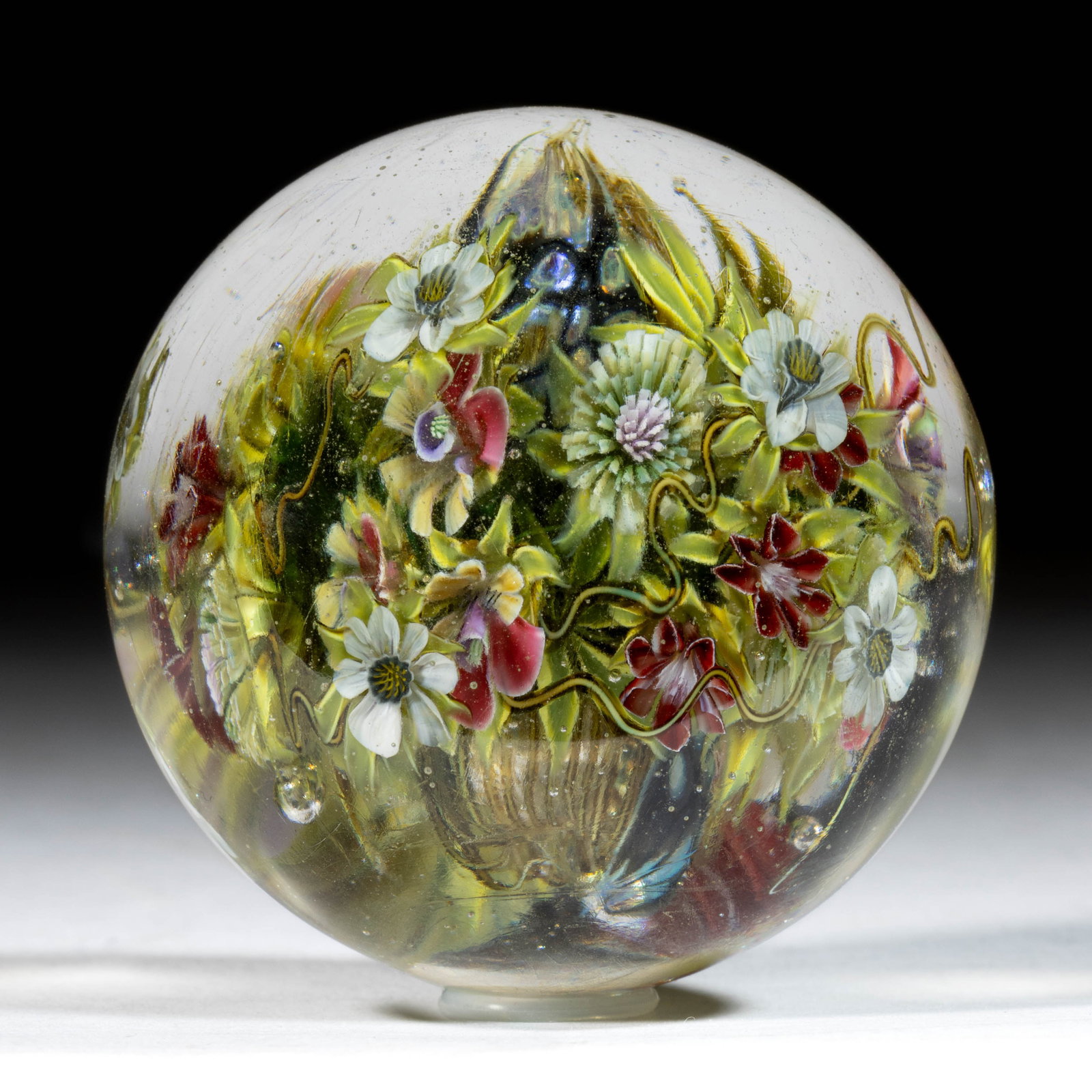 ELENA HERNBURG (RUSSIAN, B. 1960) HOLLOW STRIPED AND OPAL CORE WITH FLORAL MURRINE AND LAMPWORK: ELENA HERNBURG (RUSSIAN, B. 1960) HOLLOW STRIPED AND OPAL CORE WITH FLORAL MURRINE AND LAMPWORK STUDIO ART GLASS MARBLE, large hollow core with green and brown striping, applied black and opalesc